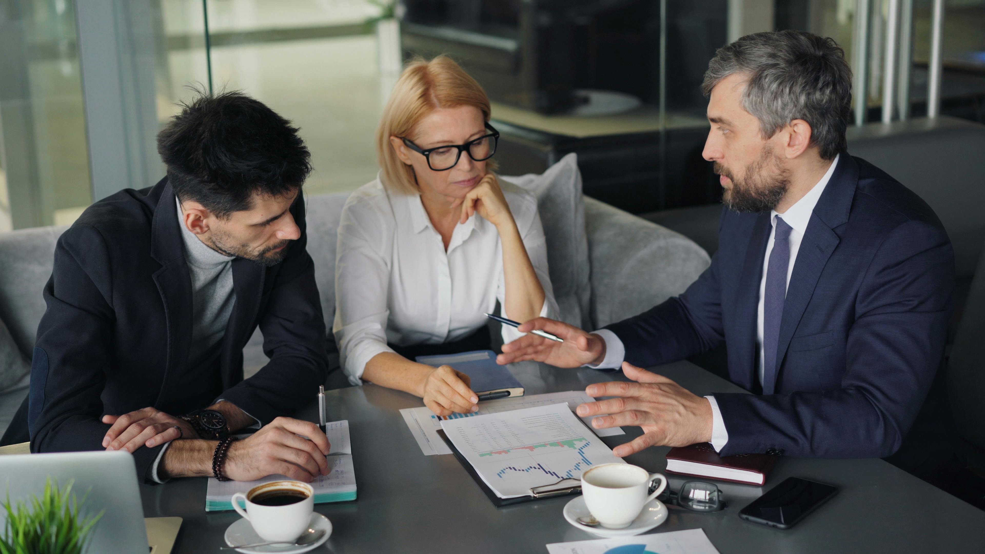 Startup entrepreneurs analyzing profit and loss statements with guidance from a Fractional CFO.