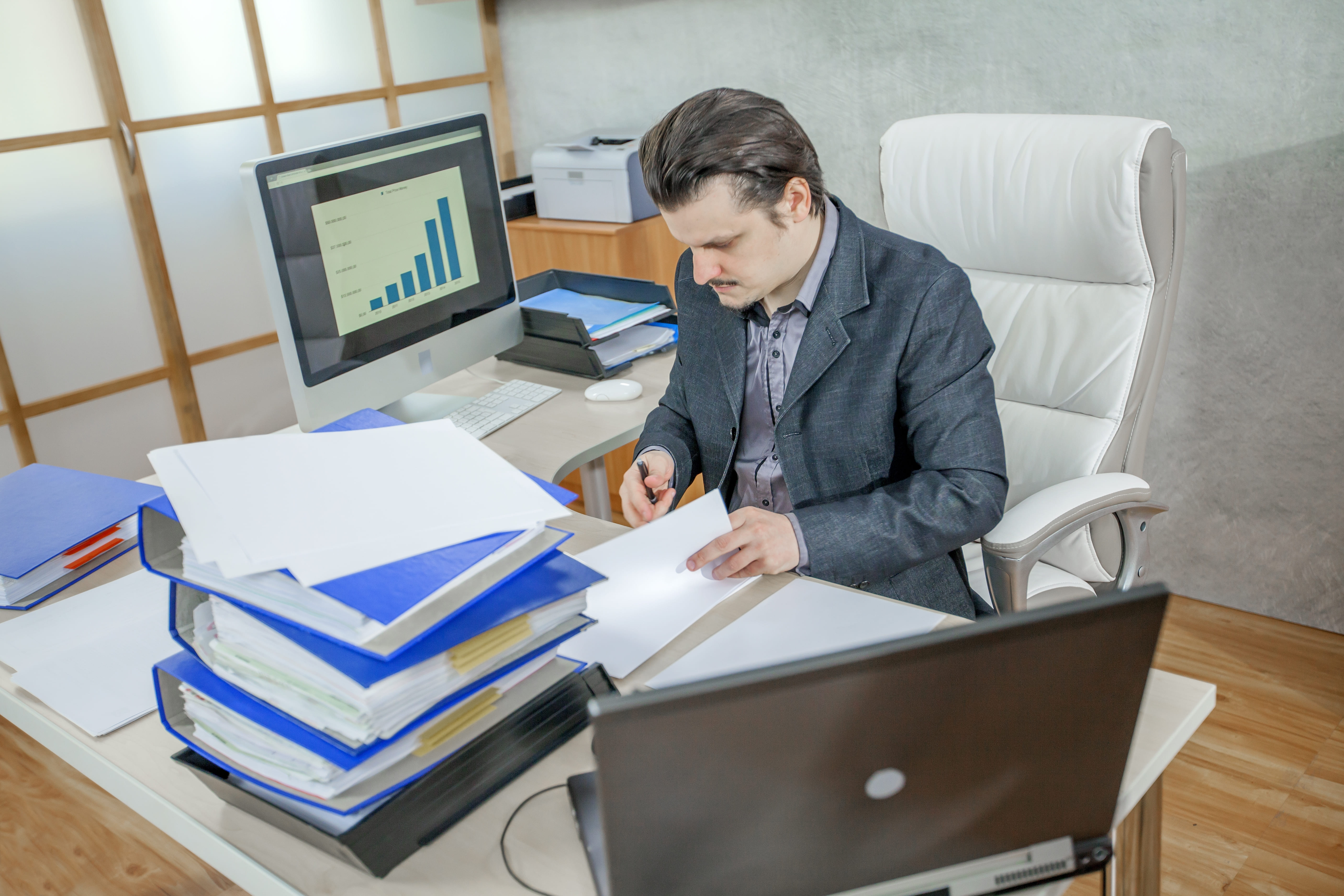 US & Canada startup founder overwhelmed by spreadsheets, illustrating the hidden cost of DIY accounting.