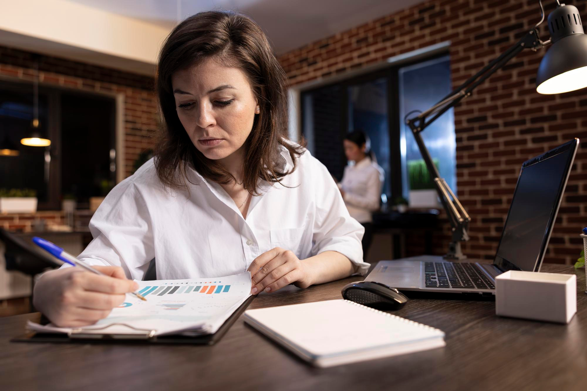 Small business owner in Canada juggling finances alone, highlighting bookkeeping mistakes entrepreneurs make.