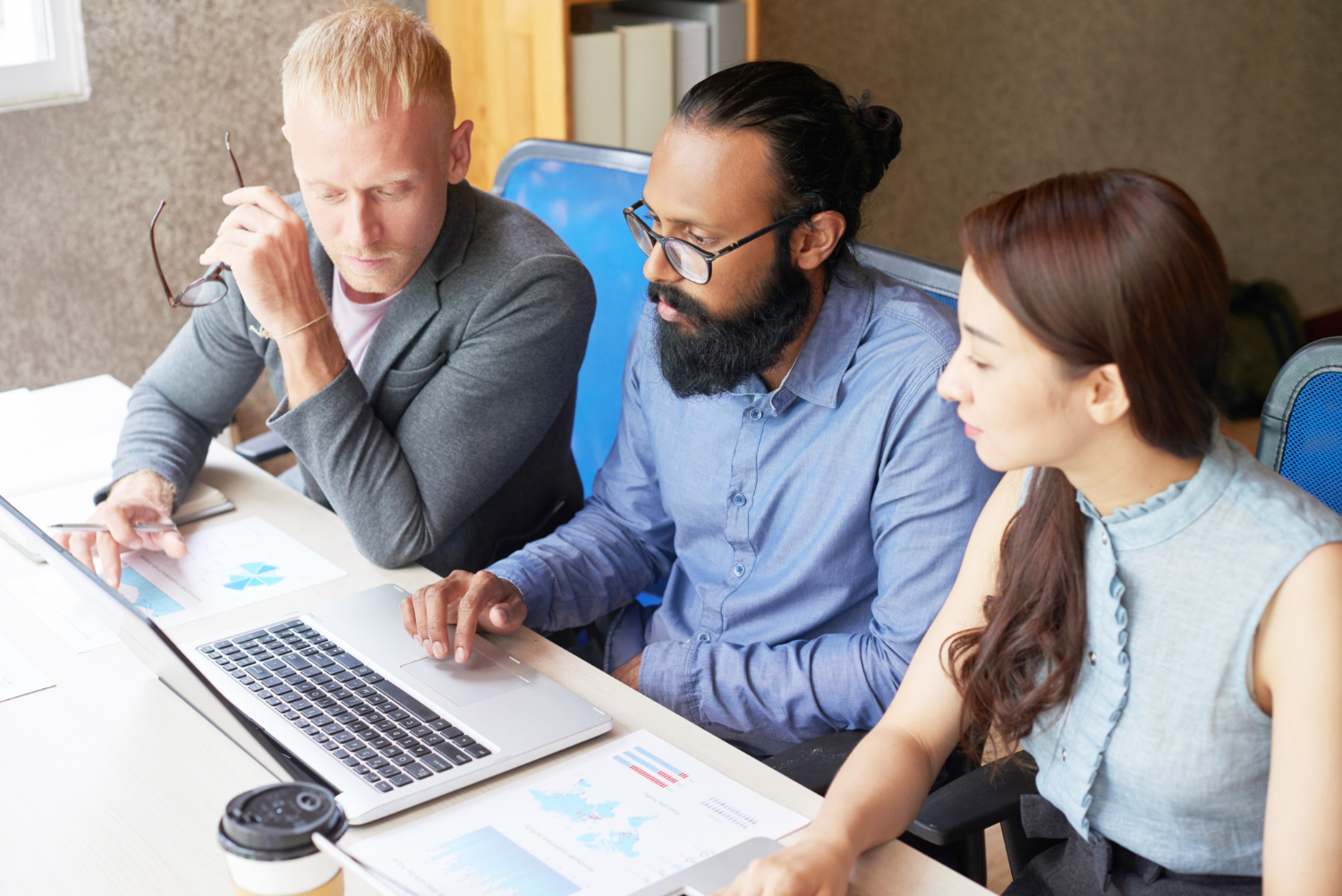 Startup team reviewing Xero vs QuickBooks for business finance management tools.