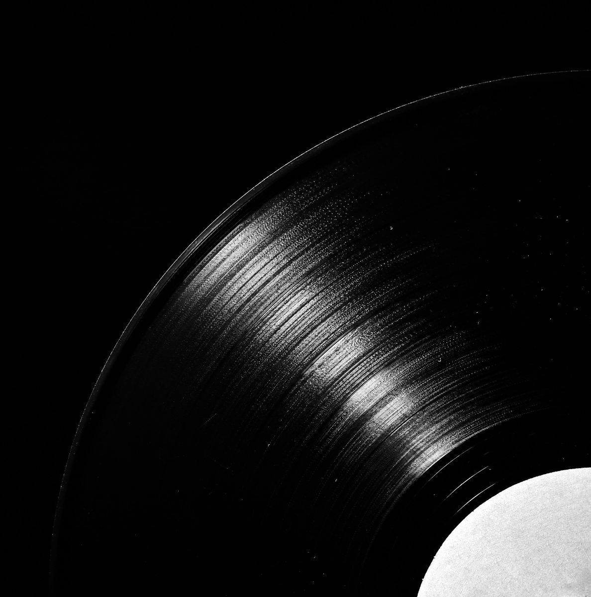 Close-up of a vinyl record with a sleek black surface, representing timeless music and artistry—perfect for BR Marketing Group, experts in promoting music brands and amplifying artists' reach.