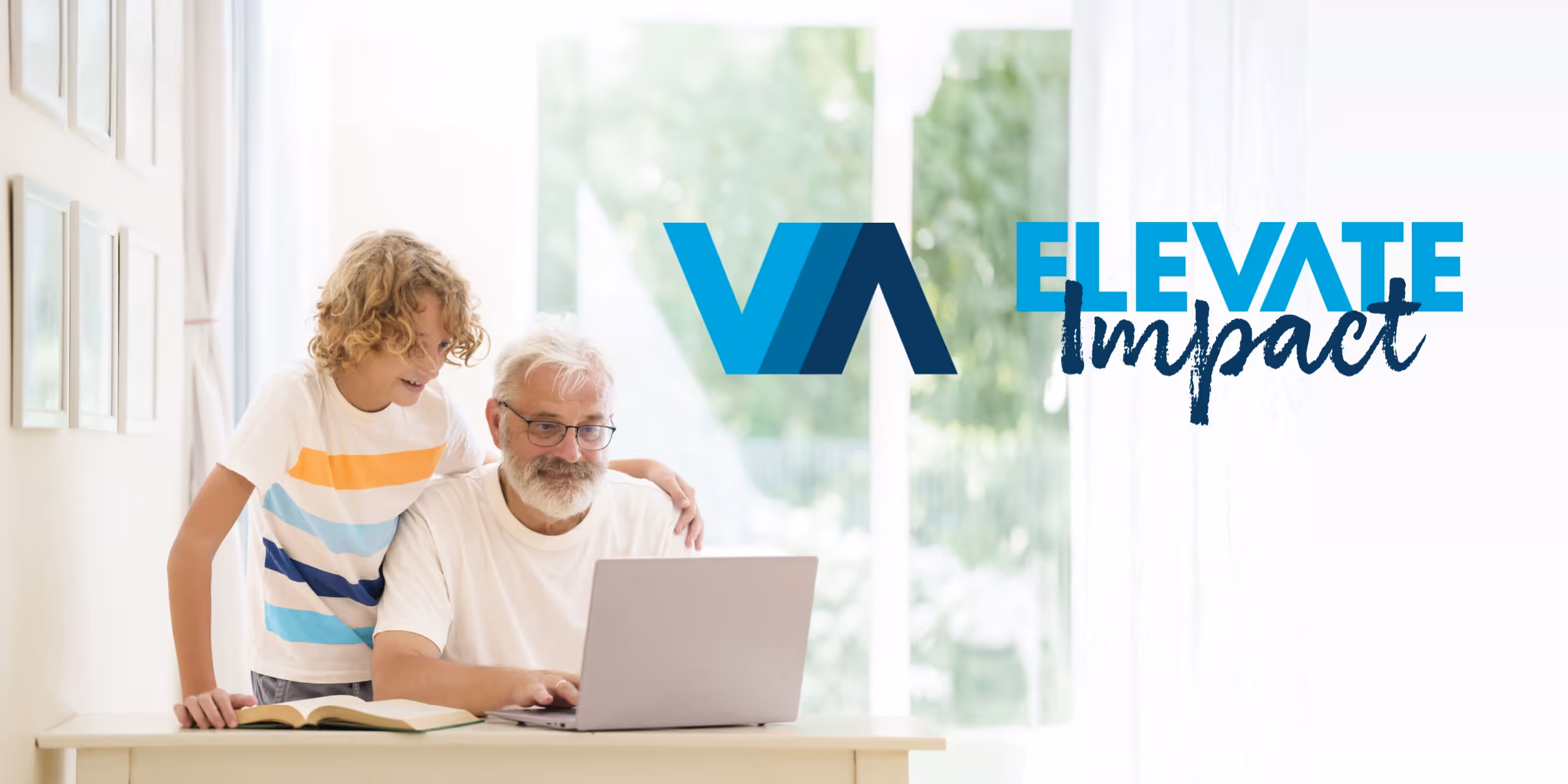 Photo of grandfather and grandson using a laptop