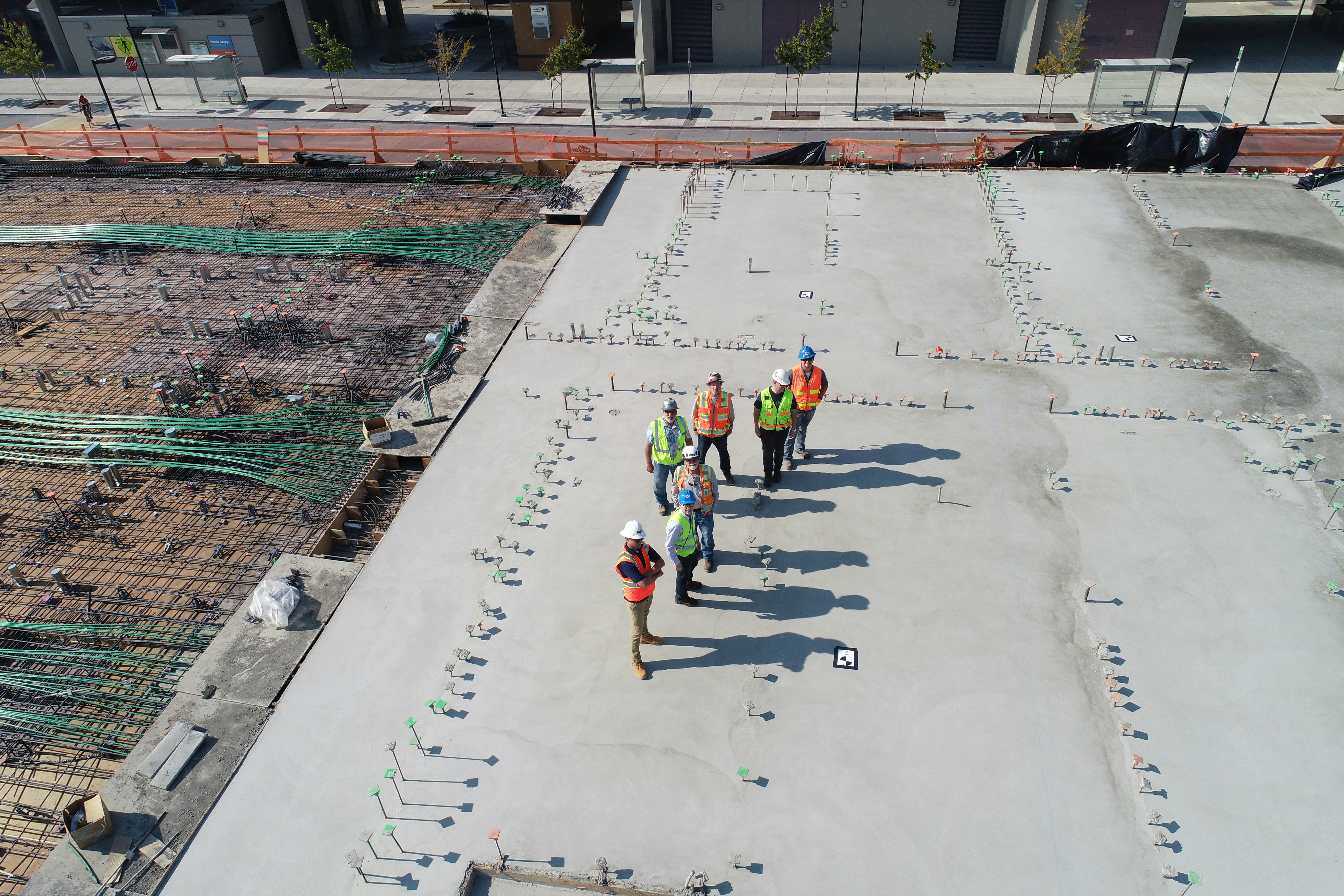 on-demand construction workers on a job site, aerial view