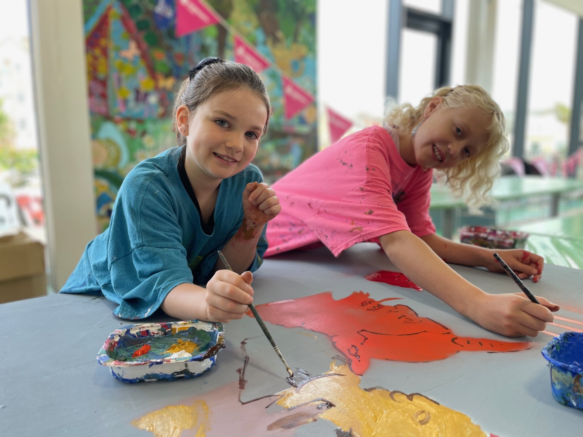 Two young girls painting