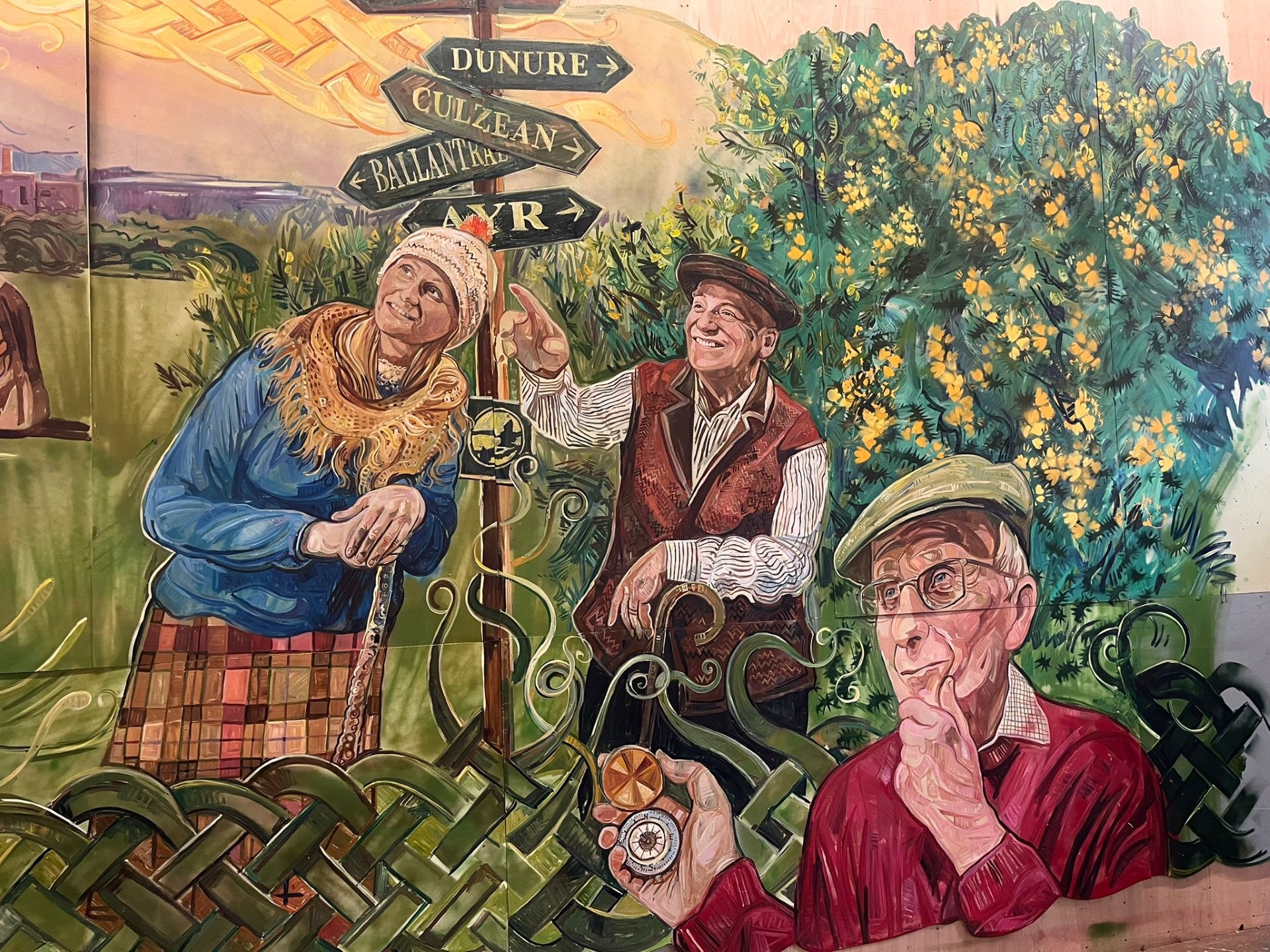 A painted section fo the mural in the Alloway Tunnel, showing a lady, two men and a sign post.