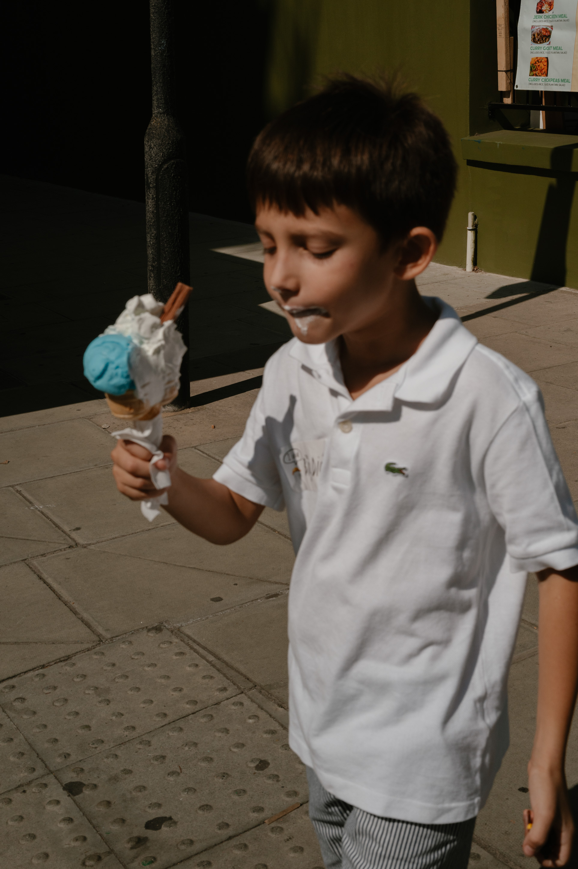 young boy eating ice cream on a hot summer day in London