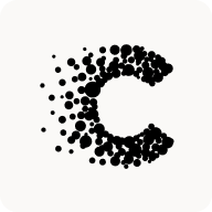 Man with beard in a blue suit and white shirt sitting at a table with clasped hands.