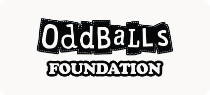 Man with beard in a blue suit and white shirt sitting at a table with clasped hands.