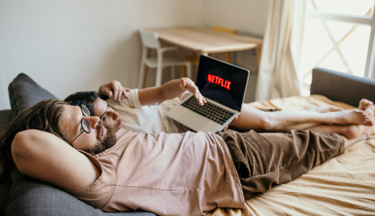 couple watching tv in bed