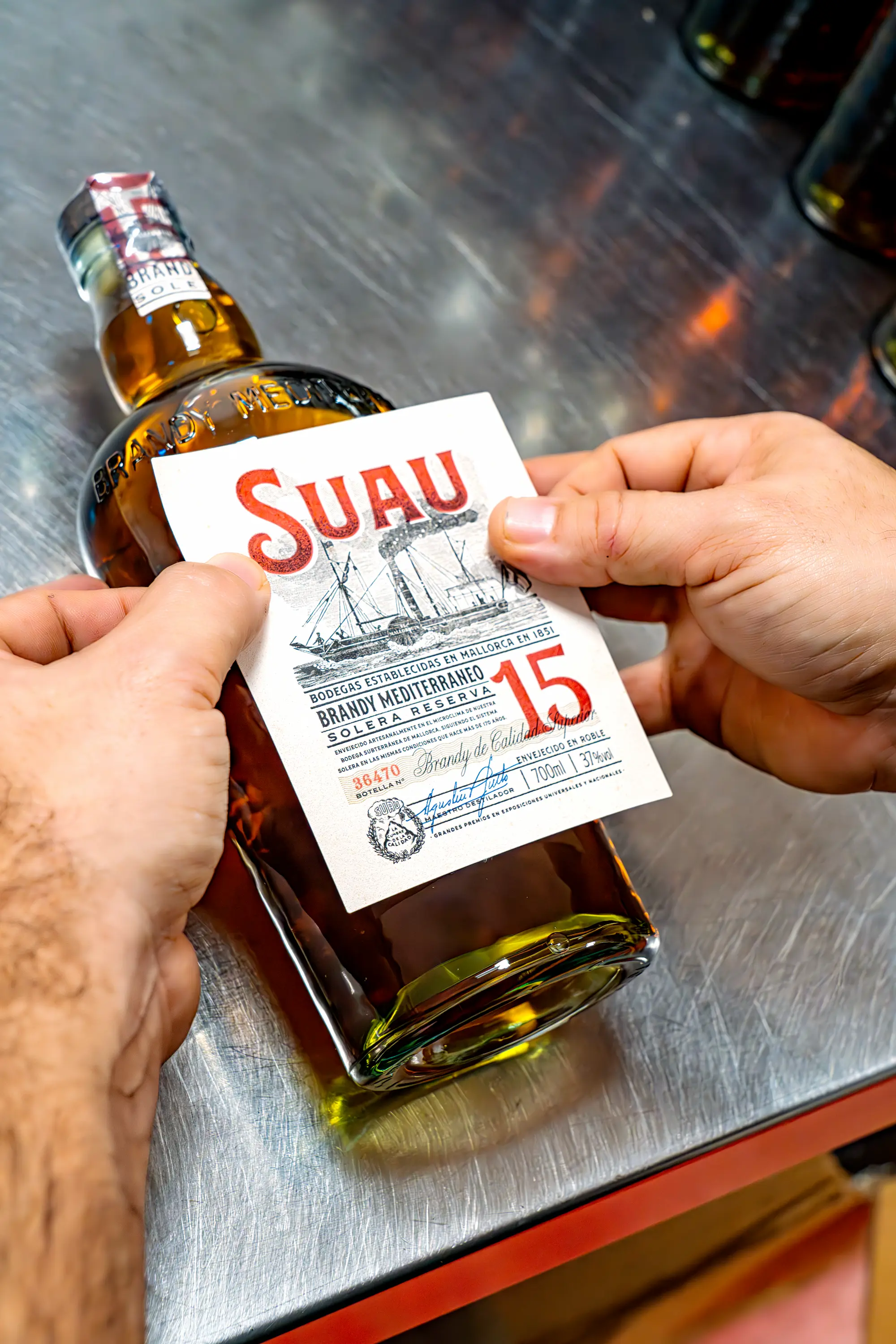 Labelling each bottle by hand. Photo: Duncan Kendall