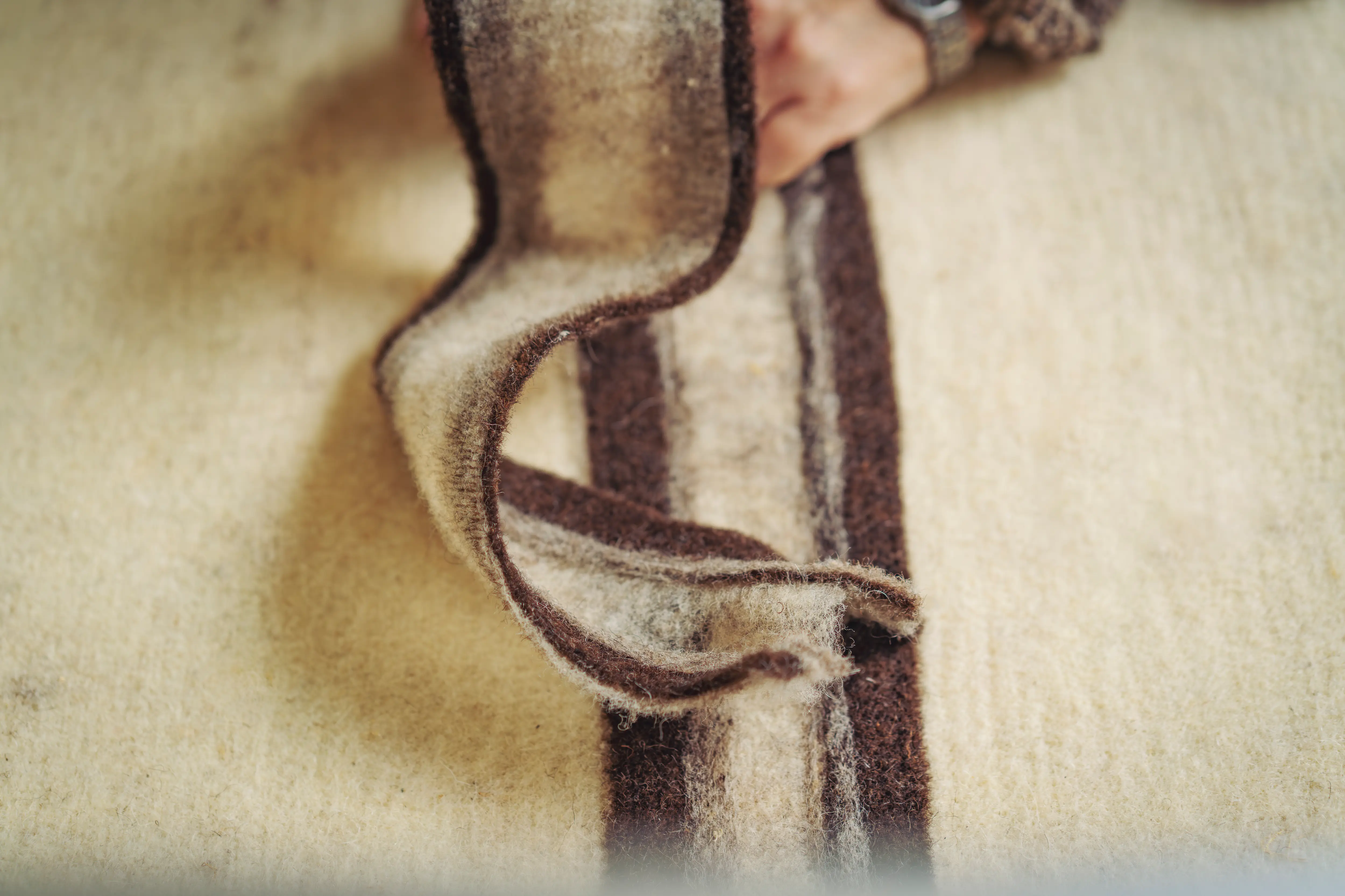 A mix of white and brown felted wool being prepared at the studio