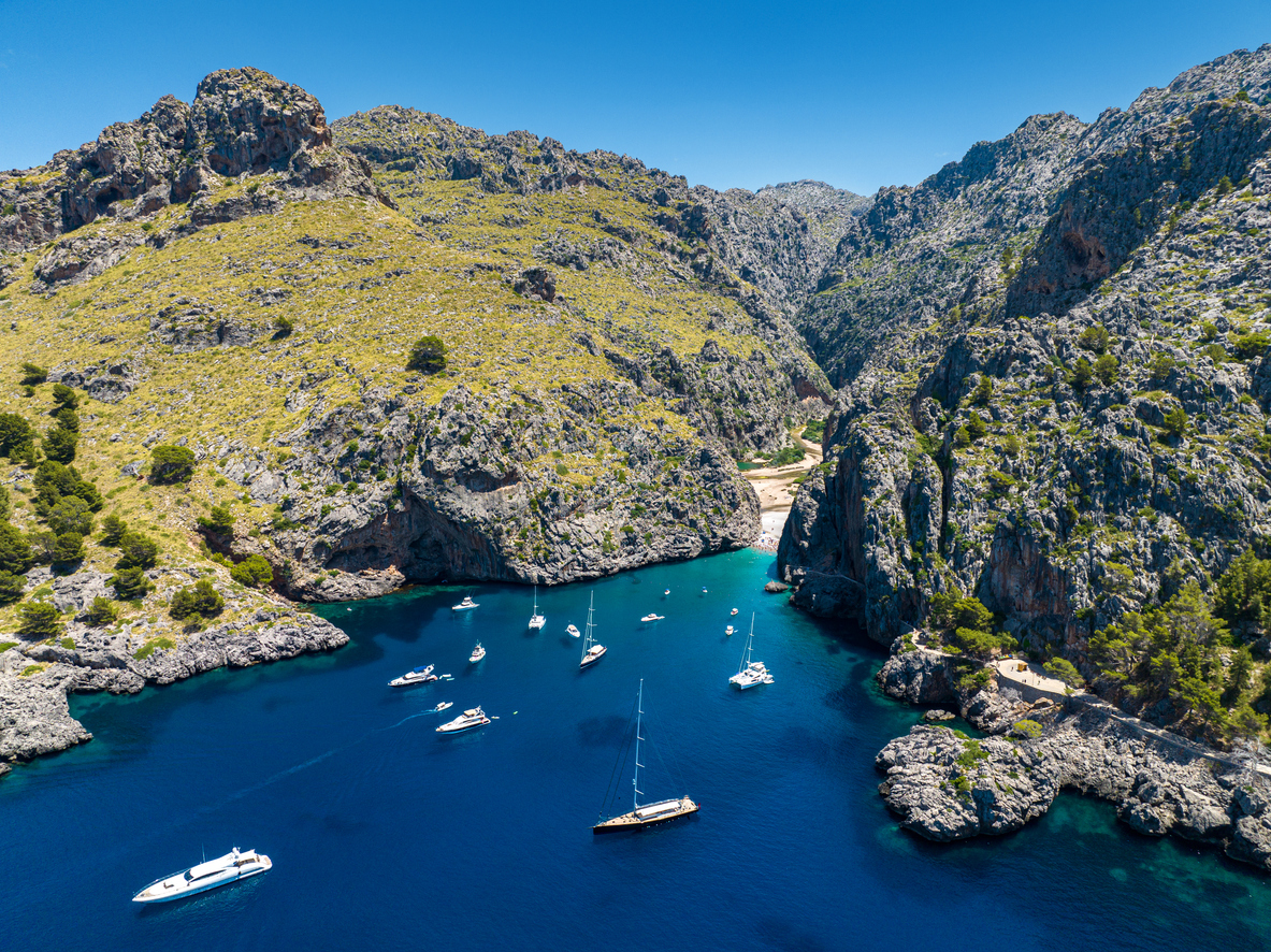 Bay of Sa Calobra with boats on dark blue water