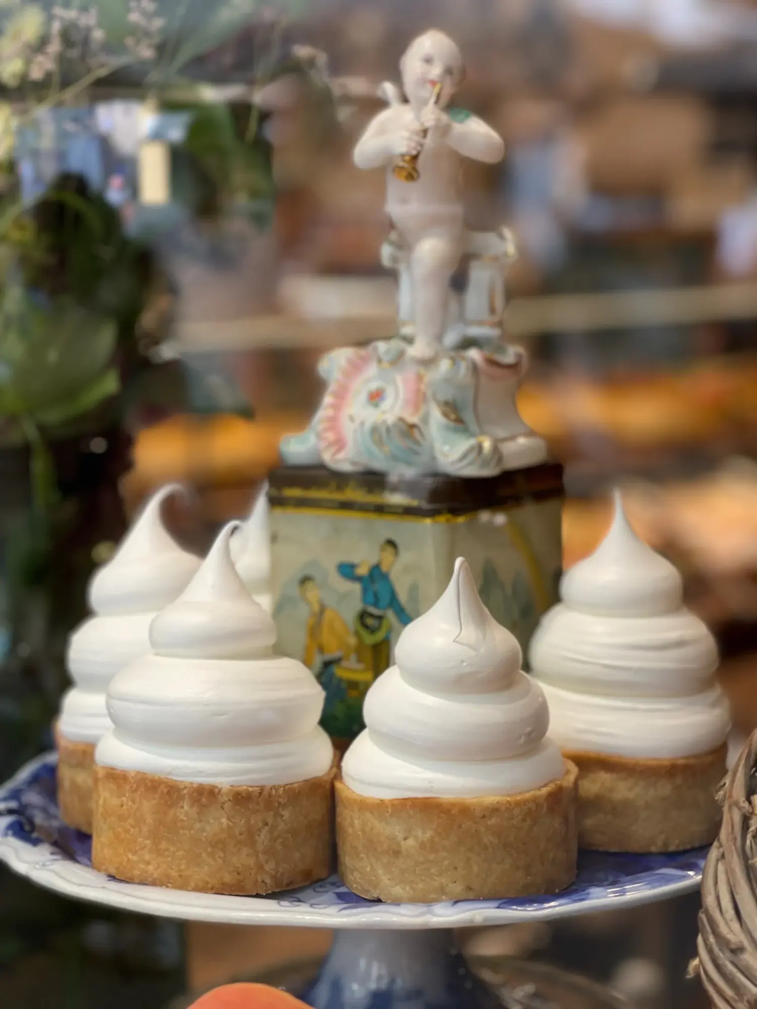 Cakes topped with swirled icing on a tray