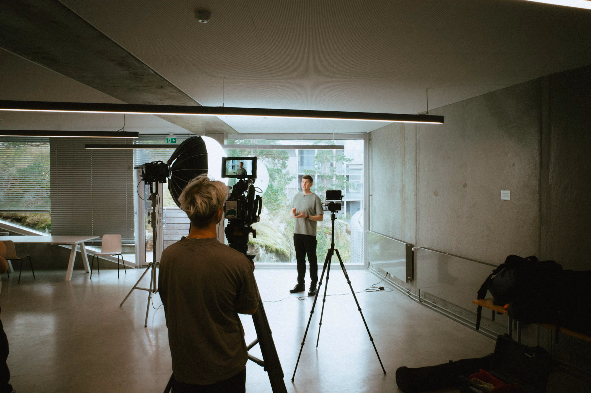 Tabora Visuals crew filming an on-camera interview in a bright concrete studio