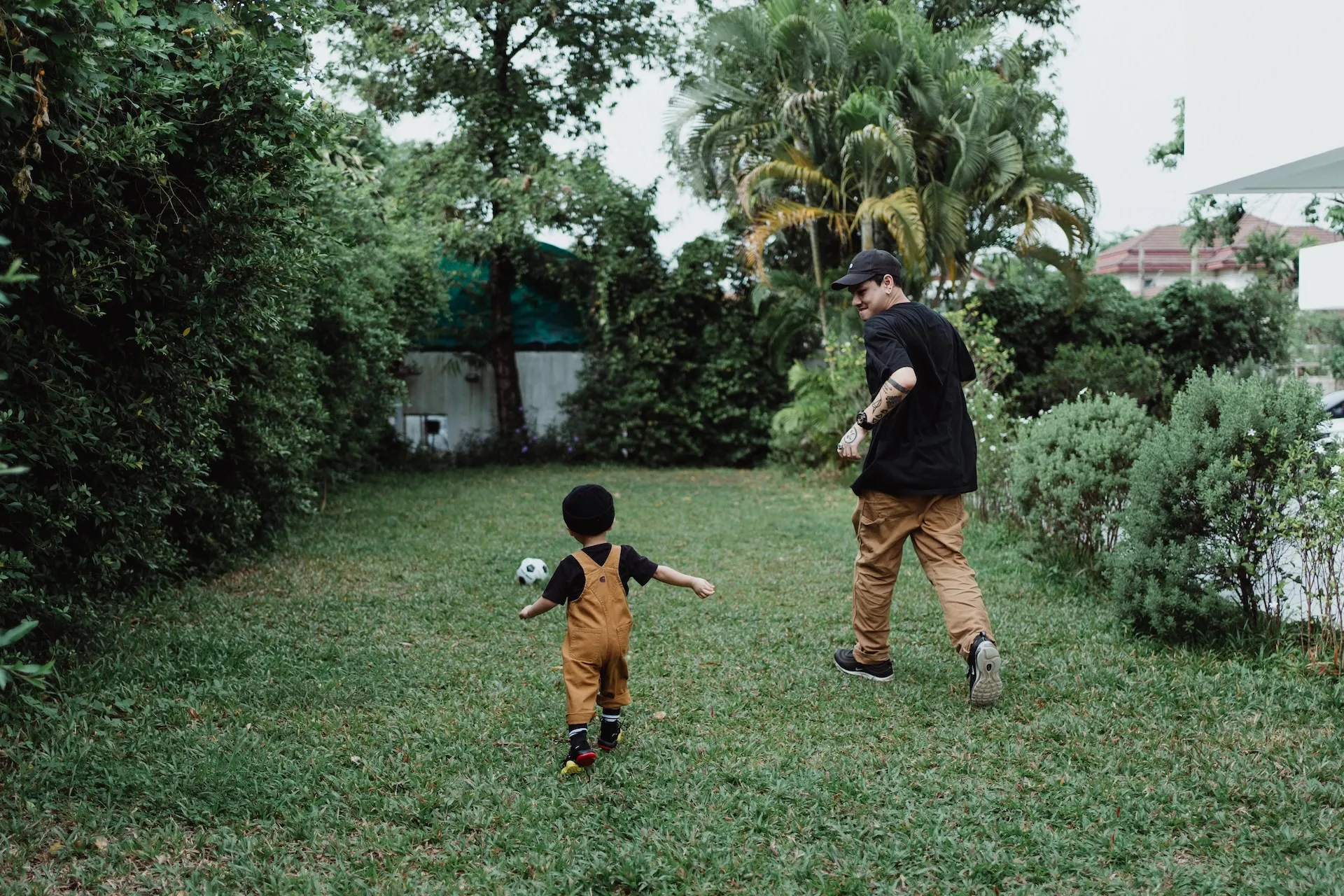 family playing soccer in yard