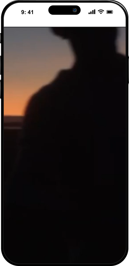Silhouette of a person against a sunset sky displayed on a smartphone screen.