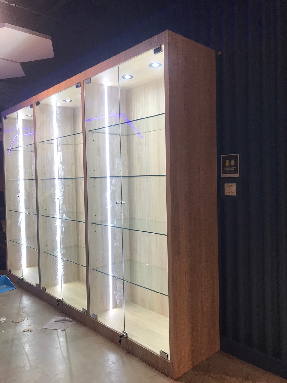 Custom display cabinet with glass door and lighting fixures.