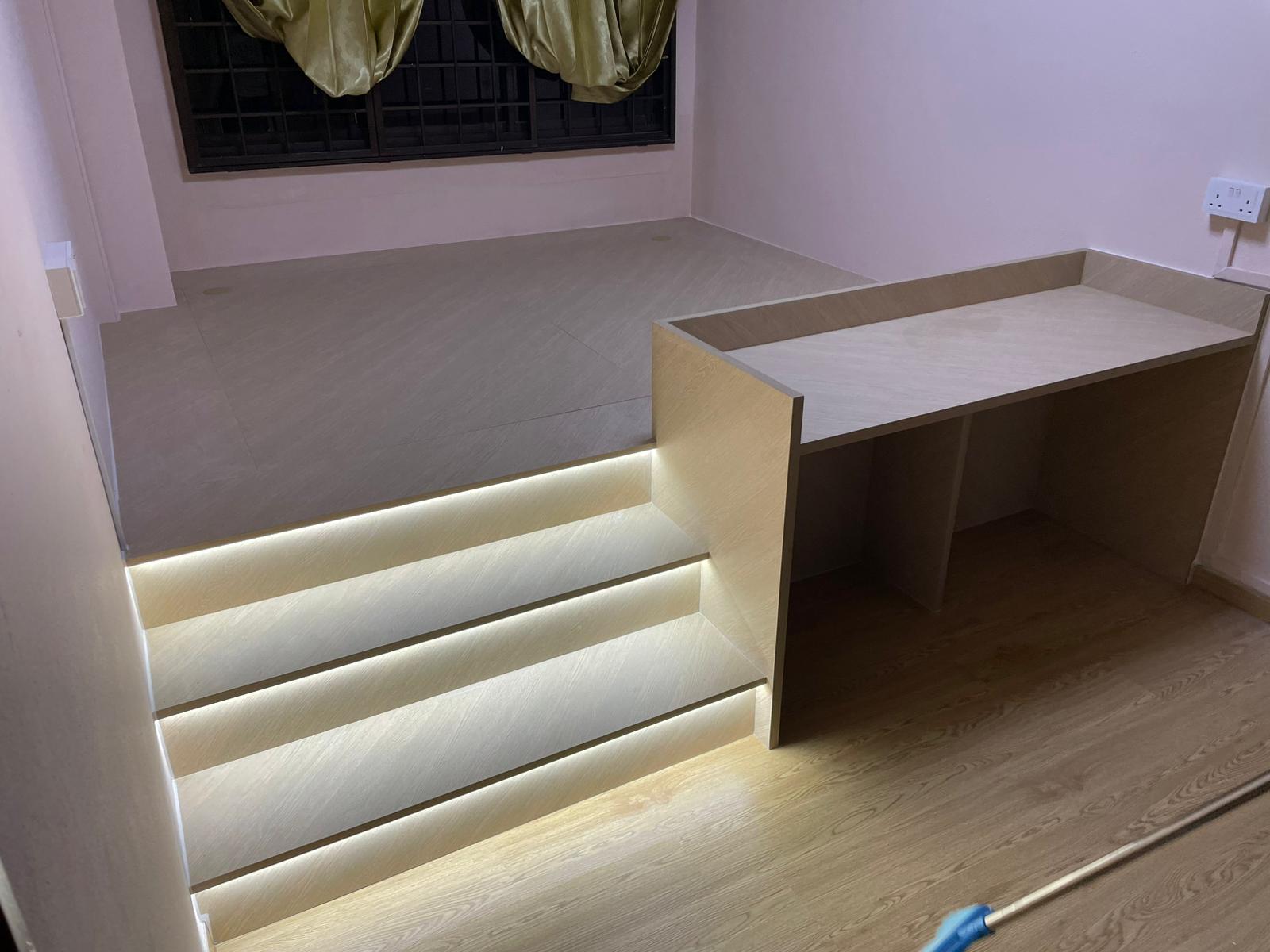 Custom wooden platform bed with steps, table and light fixtures