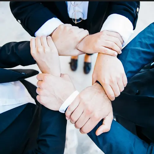 Business team joining hands together symbolising cross-sector collaboration for Australian Cyber Security Strategy - Legalfinda