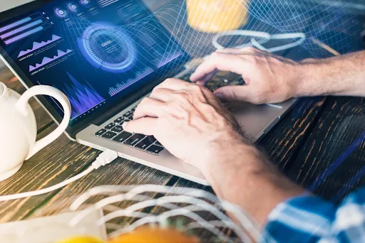 Software developer coding on laptop with cybersecurity data charts to protect intellectual property and software code - Legalfinda