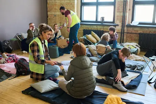 Volunteers assisting asylum seekers and refugees with application process in Adelaide community center - Legalfinda