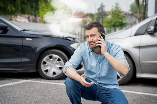 Distressed driver calling insurance after car crash representing Gold Coast accident claim time limits - Legalfinda