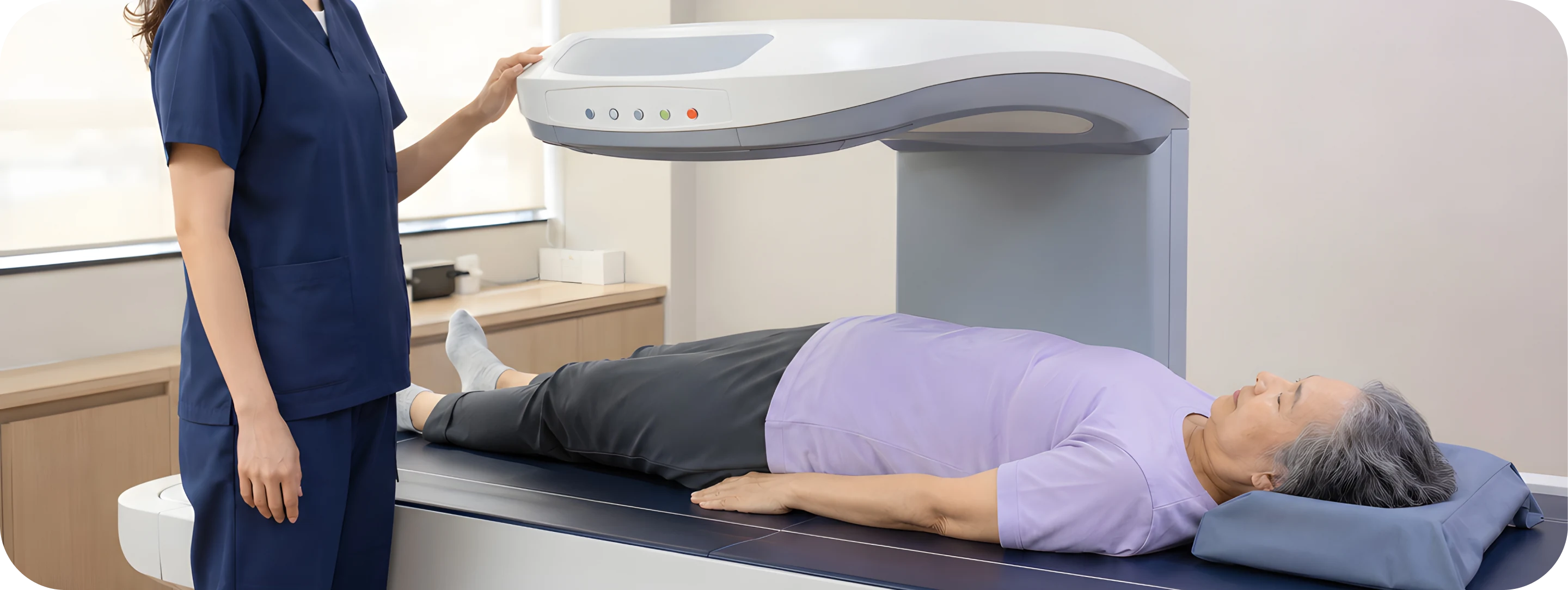 Radiographer beside a patient having a DEXA scan