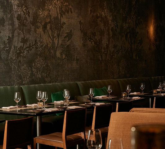 A single prepared place setting beside an empty chair