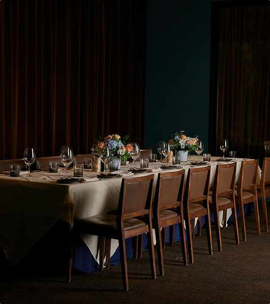 A lamp-lit place setting at a private dinner table