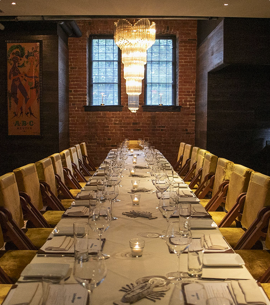 A lamp-lit place setting at a private dinner table