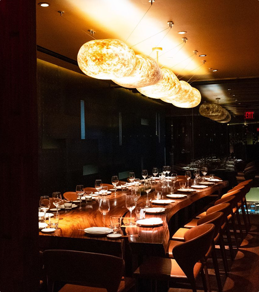 A lamp-lit place setting at a private dinner table