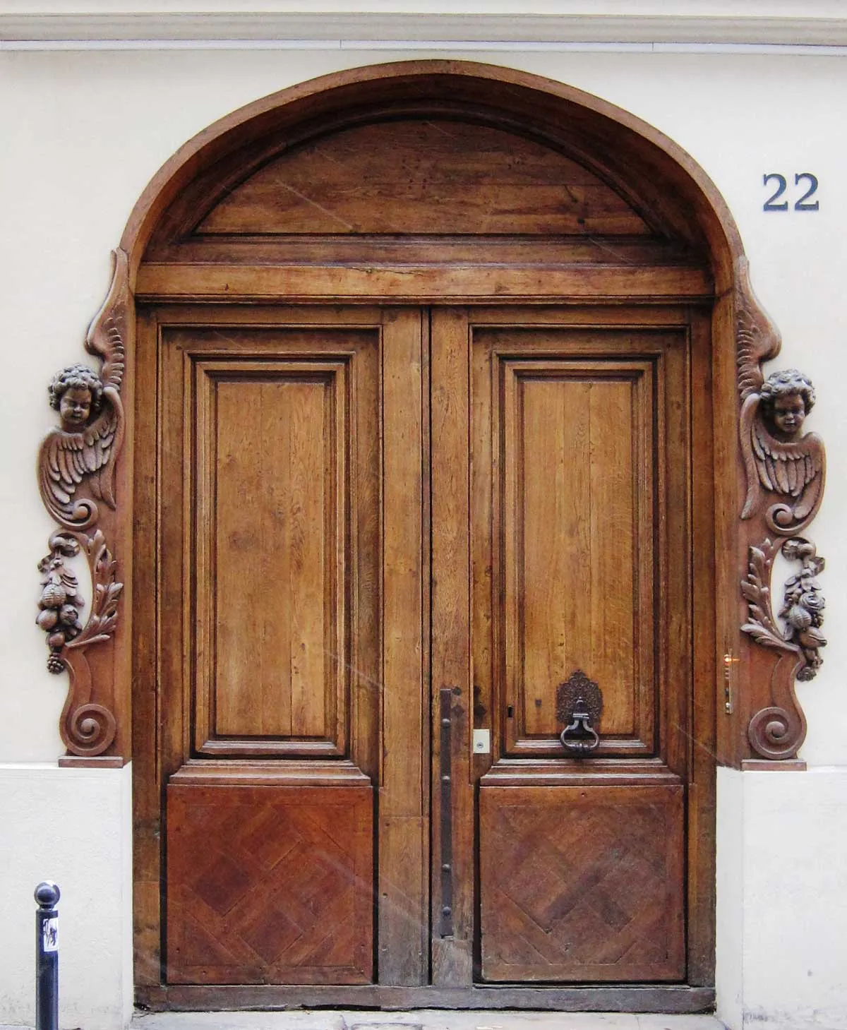 Carved wooden carriage entrance door of a Parisian building