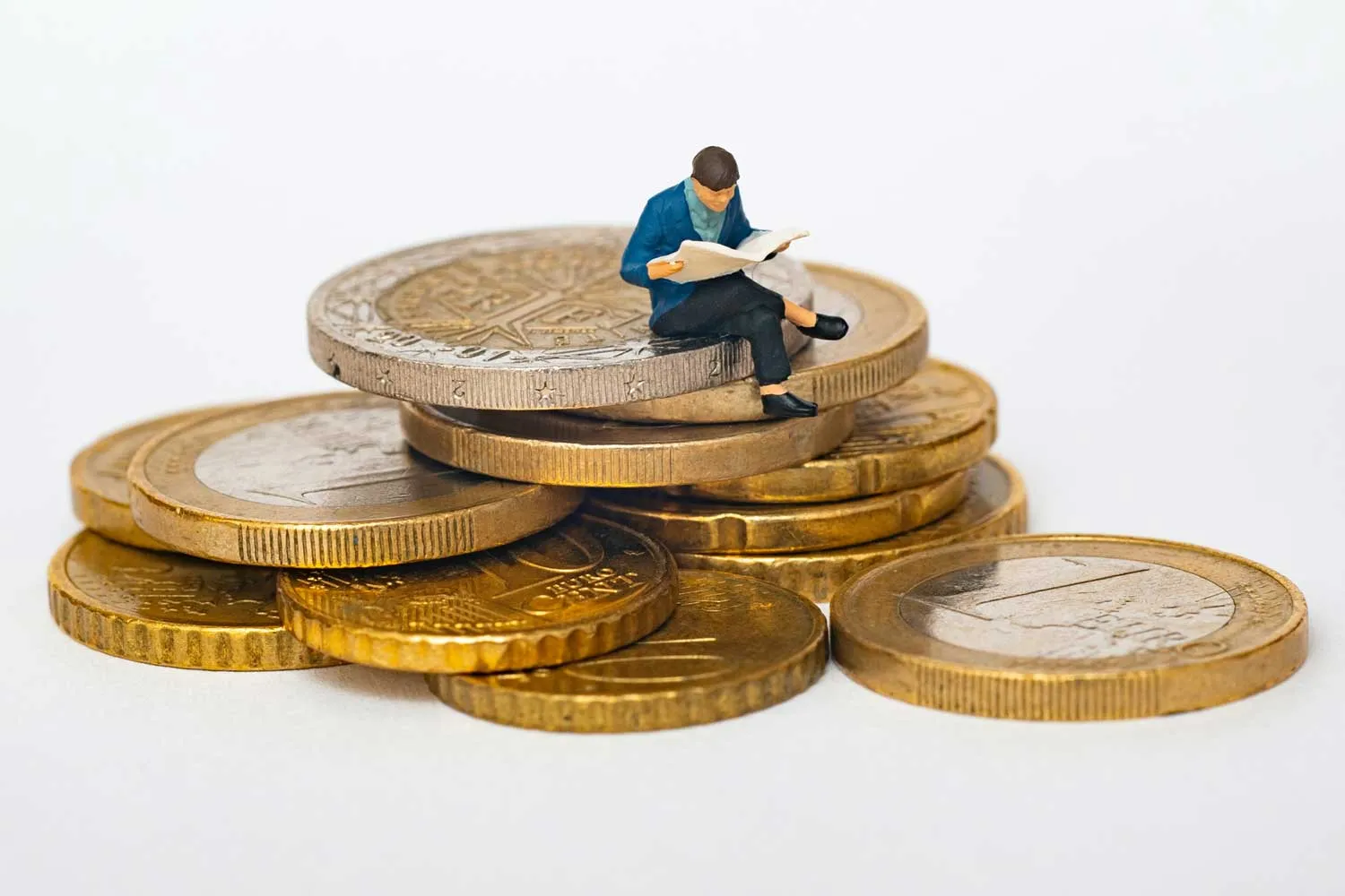 illustration: a man reading a document while sitting on a pile of coins
