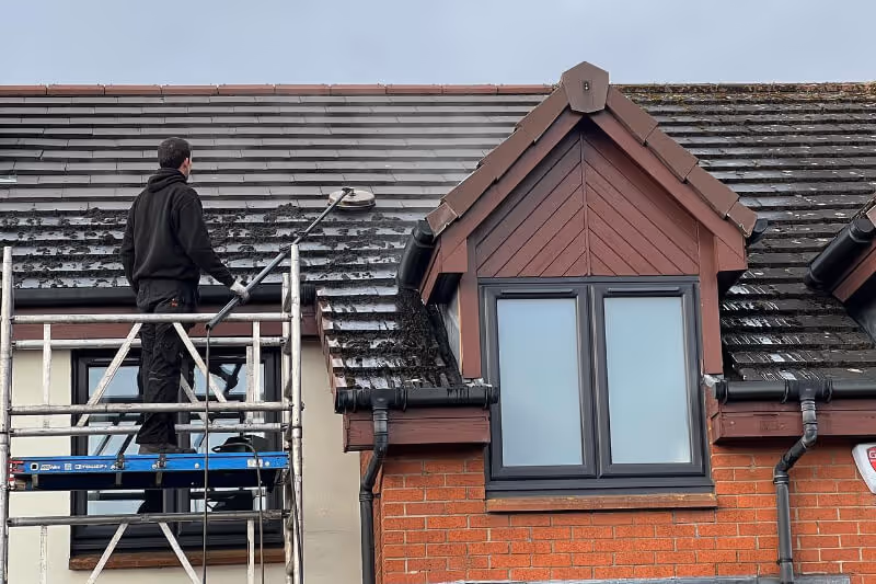 Roof cleaning using soft washing