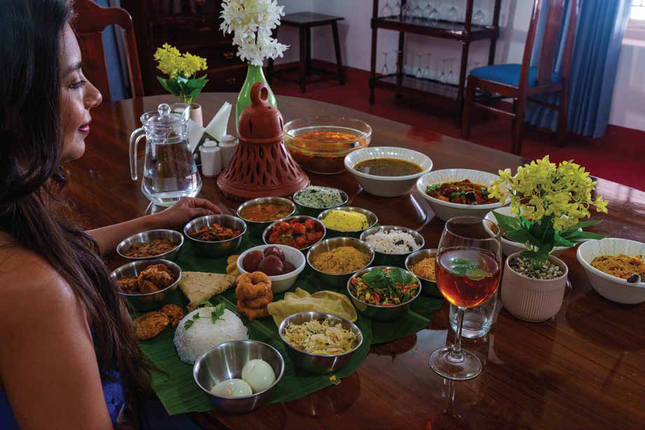 A traditional Kerala meal served on a banana leaf at a plantation bungalow