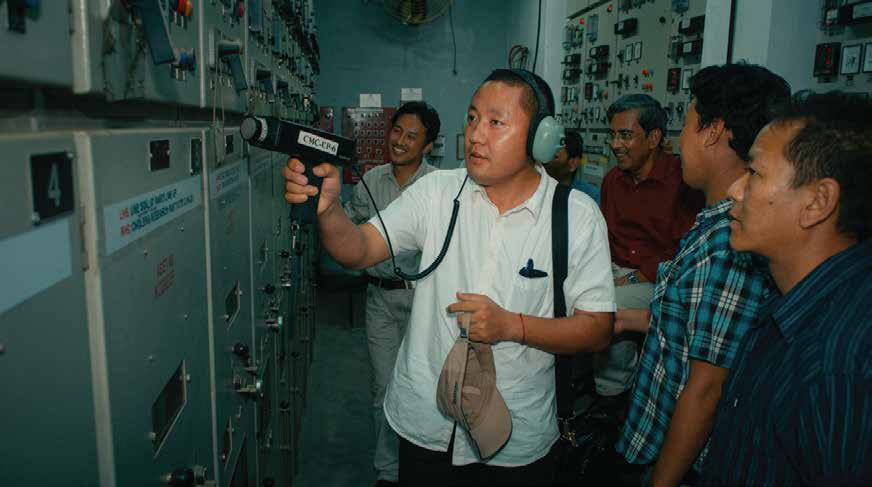 AIPM participants receiving hands-on training in a power distribution control room