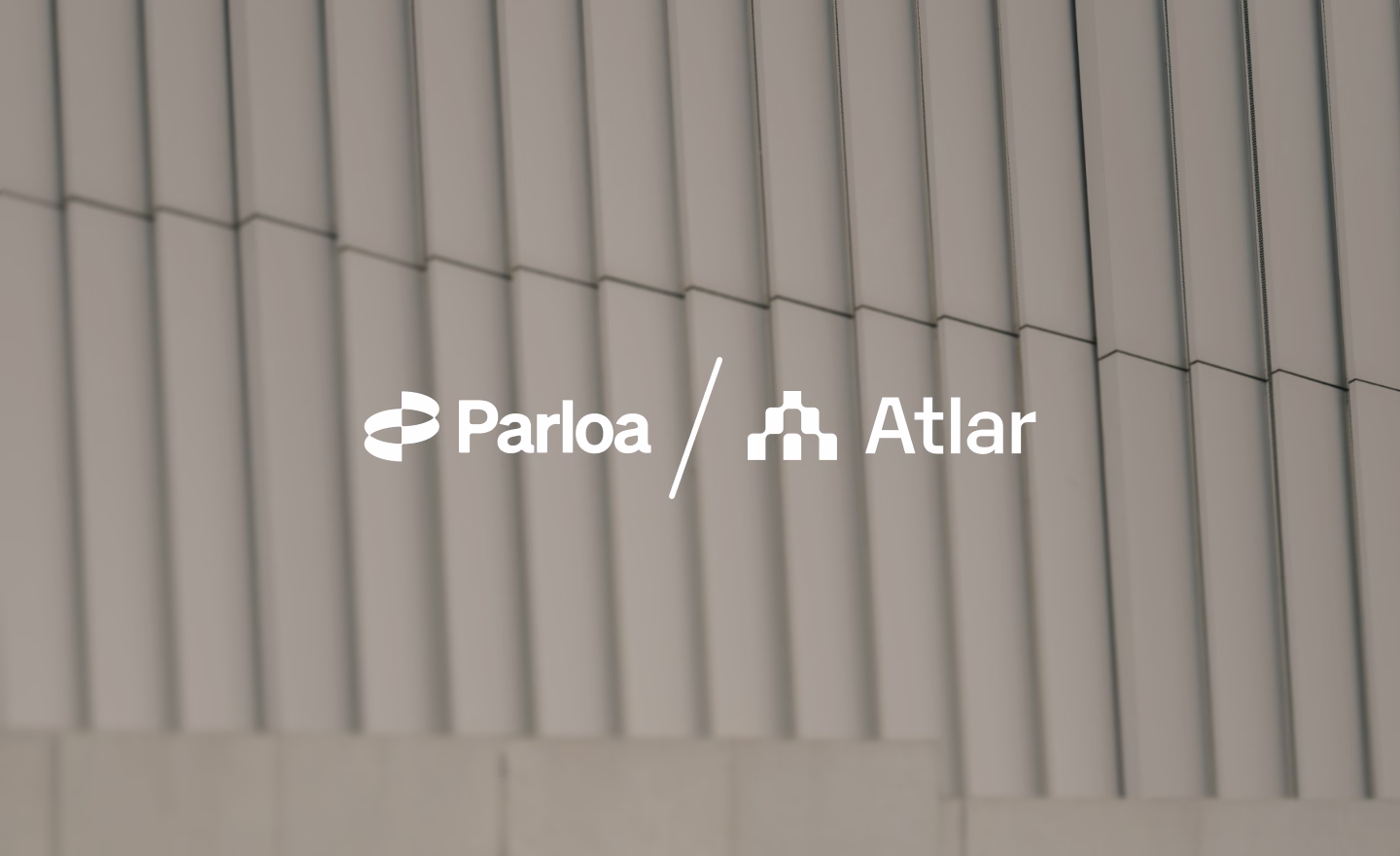 Parloa and Atlar logos side by side over a blurred building facade, announcing the partnership