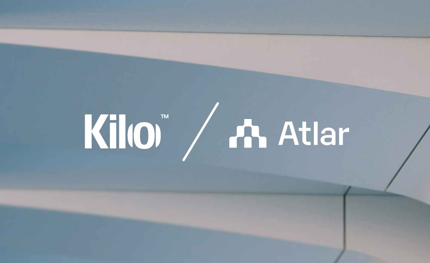 Kilo and Atlar logos side by side over a blurred building facade, announcing the partnership