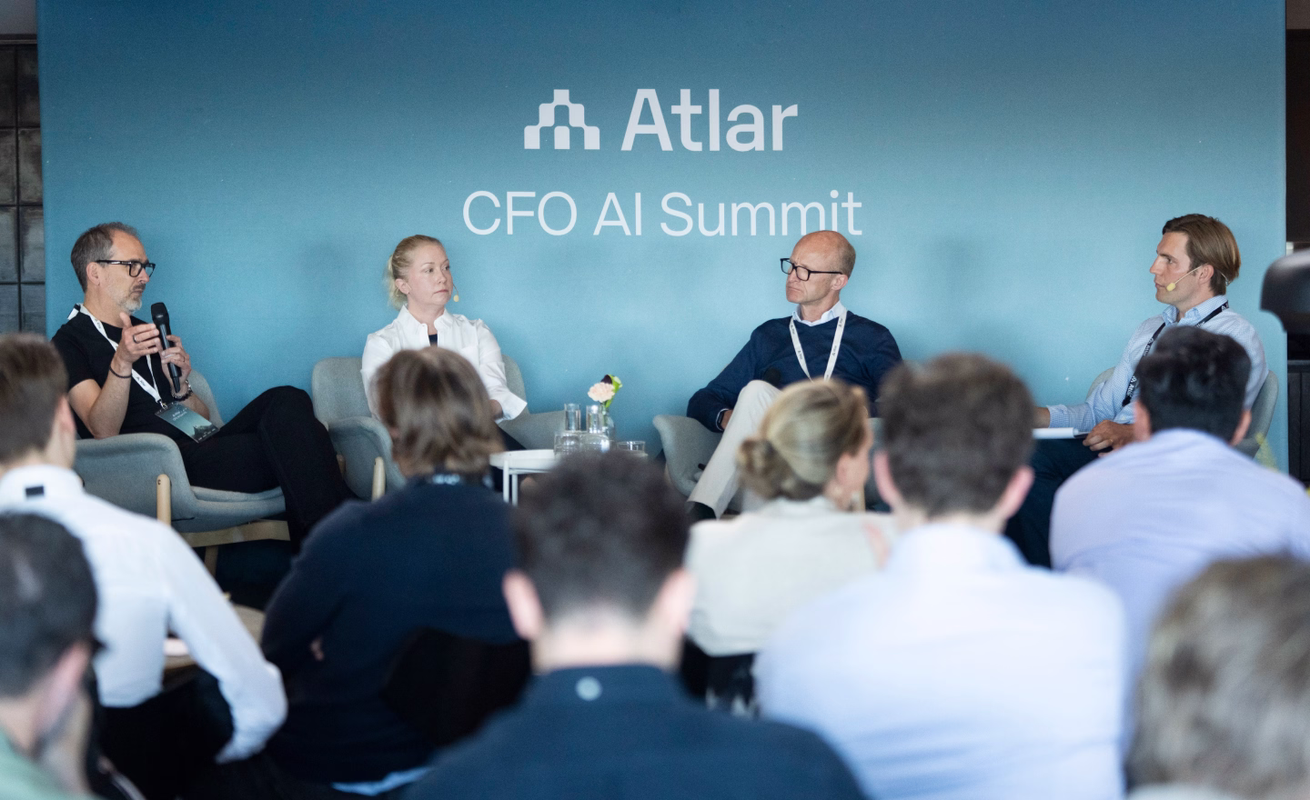 Panel of speakers on stage at the Atlar CFO AI Summit 2026 with an audience in the foreground