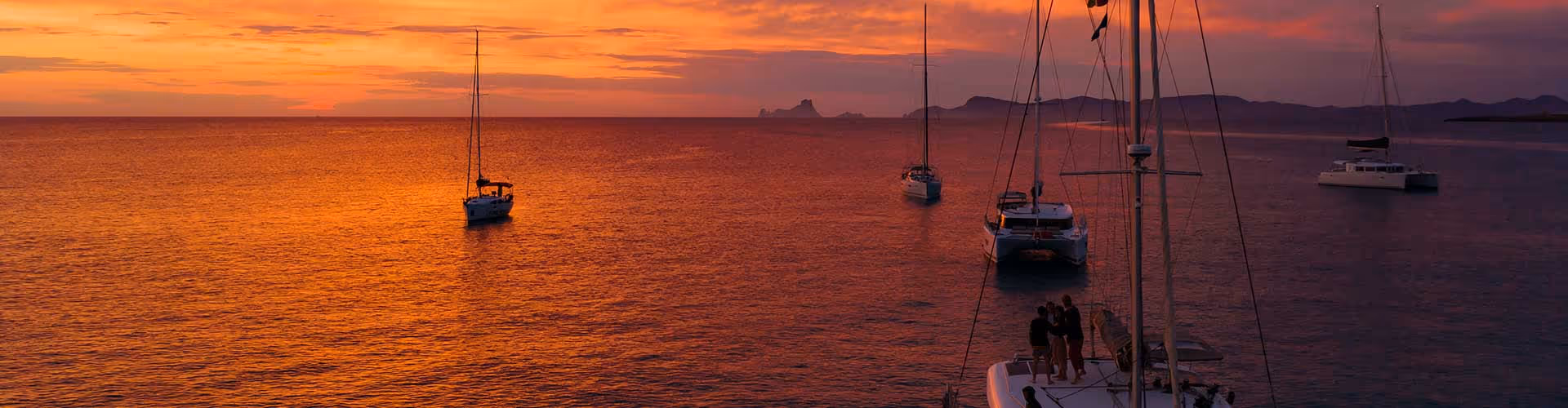 A group of boats floating on top of a body of water.