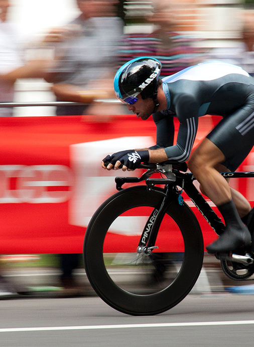 Cyclist wearing an orange jersey at full speed