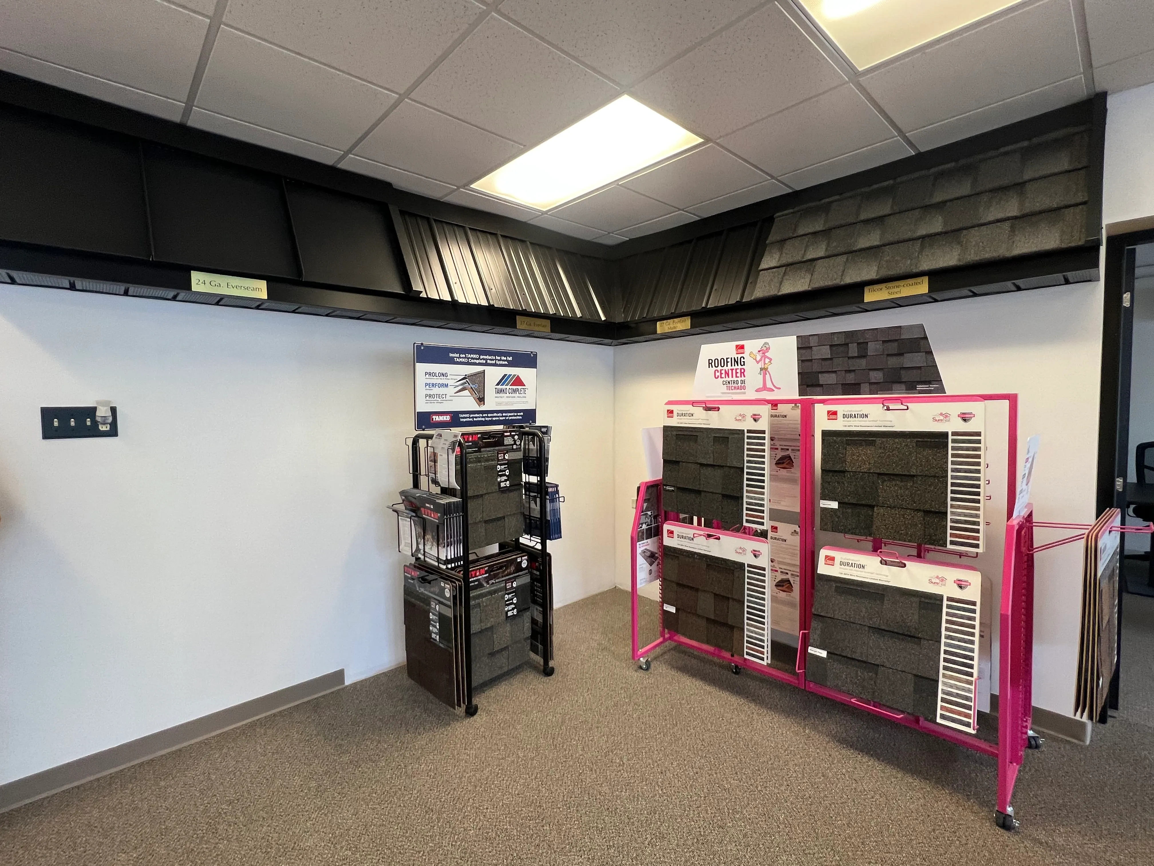 Tip Top Roofing & Siding showroom featuring metal roofing samples and asphalt shingle displays from trusted brands.