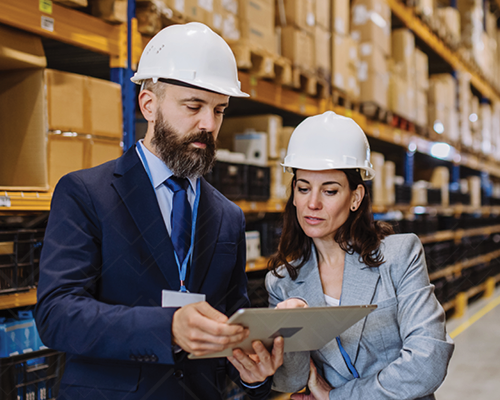 warehouse worker holding crate of beer in distribution center
