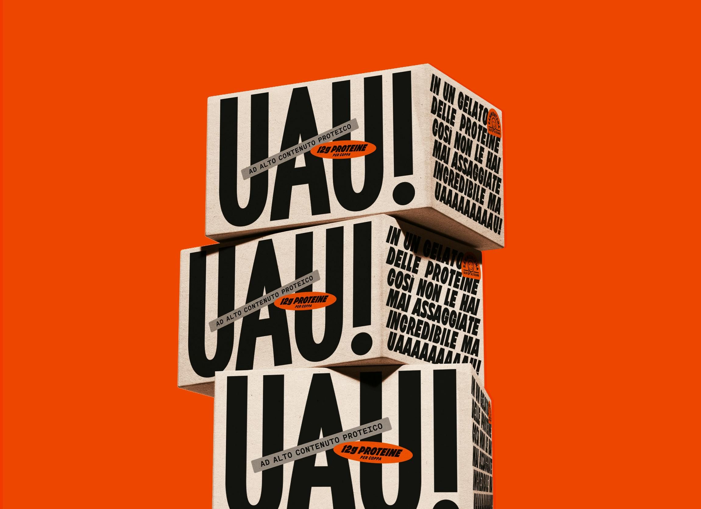 Stacked cartons on a vivid orange ground printed with an oversized UAU! wordmark and dense small type
