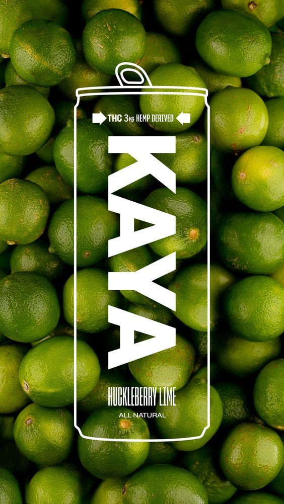 Kaya hard seltzer can standing on a bed of fresh limes with bold white type