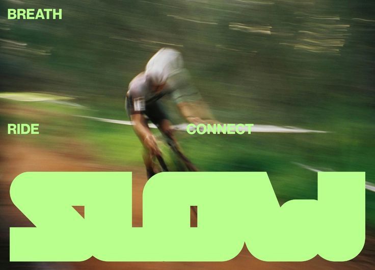 Blurred cyclist in green fields with a large reversed SLOW wordmark and breath, ride, connect labels