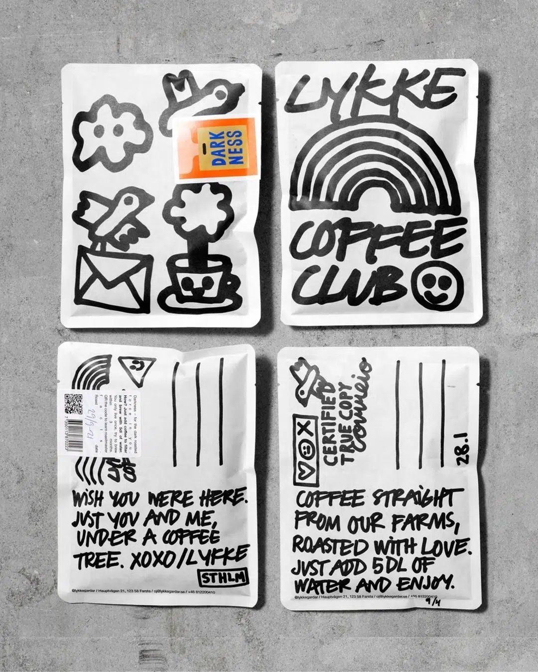 Hand-drawn Lykke Coffee Club label artwork in black marker on grey card