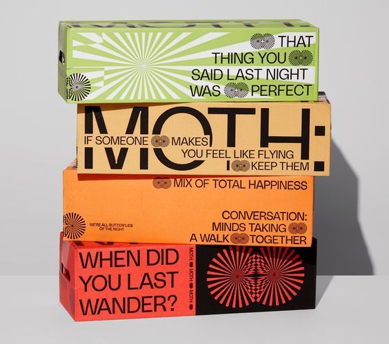 Stacked Moth conversation-game boxes in green, orange and red printed with question prompts