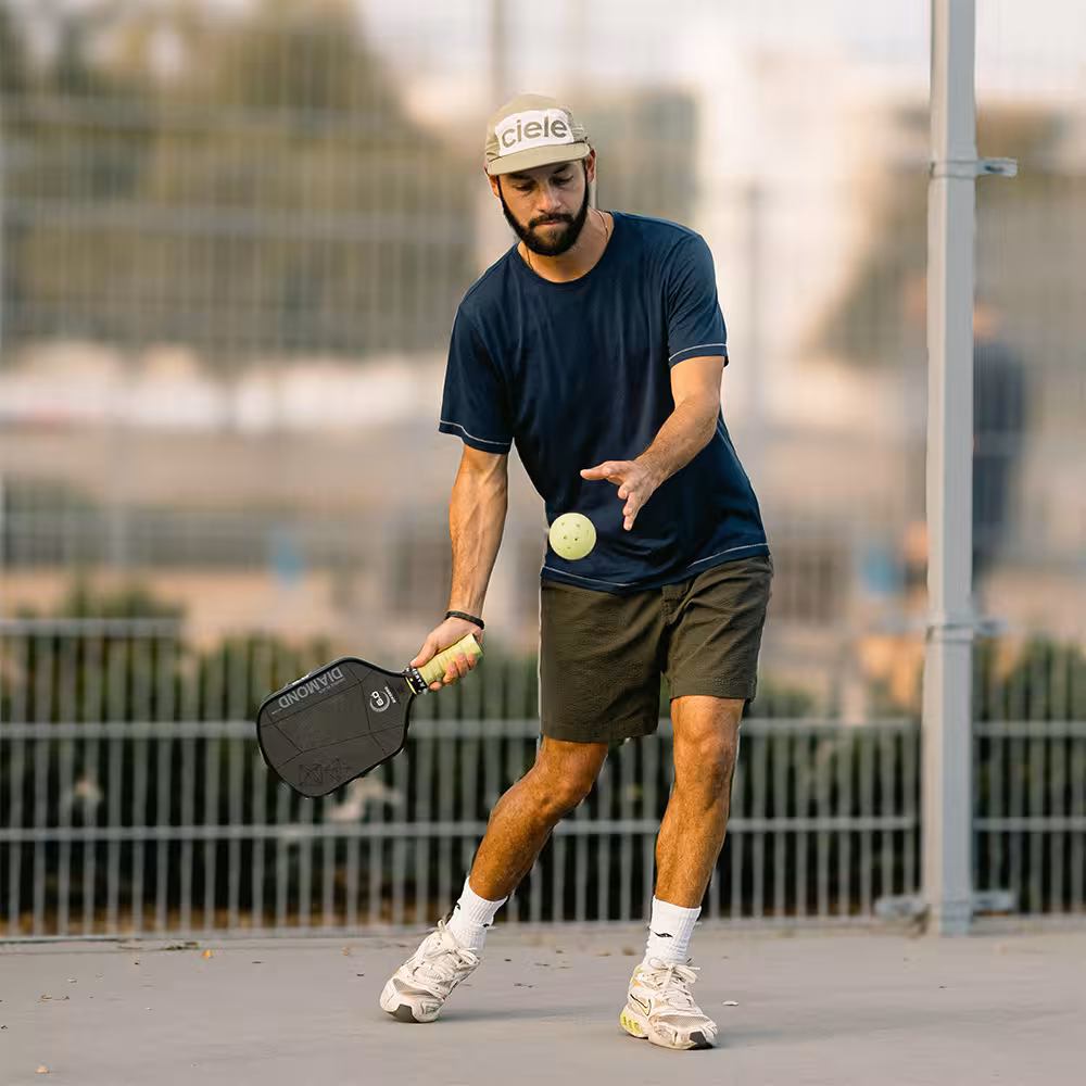 man hitting a forehand serve