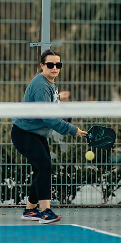 woman hitting a one handed backhand drive